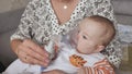 Infant getting breathing treatment from mother while suffering from illness.