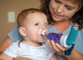 Infant getting breathing treatment from mother Royalty Free Stock Photo