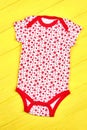 Infant girl brightful patterned bodysuit. Royalty Free Stock Photo