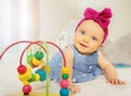 Infant girl play with bead roller coaster toy Royalty Free Stock Photo