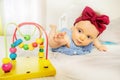 Infant girl stretch to bead roller coaster toy Royalty Free Stock Photo