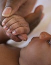 Infant grabbing mother's finger