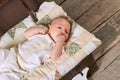 Infant with hand in mouth. Royalty Free Stock Photo