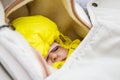 Infant sleep in baby stroller in winter forest. warmly dressed. yellow jumpsuit