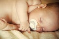 Infant sleep with pacifier in mouth Royalty Free Stock Photo