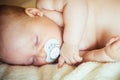 Infant sleep with pacifier in mouth Royalty Free Stock Photo