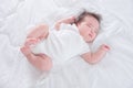 Infant sleeping on white bed in the morning Royalty Free Stock Photo