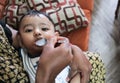 An infant toddler baby boy being fed milk with spoon Royalty Free Stock Photo