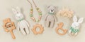 Infant toys on a pastel beige background. Wooden and crocketed baby handmade toys for a banner in eco style. Baby toys concept.