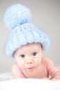 Infant wearing blue knit hat