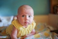 A small child confidently holds his head. The first skills of the child. Child development by months. The first month of life a