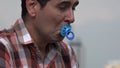 Infantile Man Using Baby Pacifier