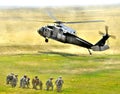 Infantry squad waiting for the Blackhawk helicopter to land. Royalty Free Stock Photo