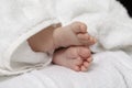 Infants Ideas and Concepts. Macro Close-up Image of a  Four Week Old Baby Boy Crossed Feet Over White Towel Royalty Free Stock Photo