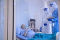 Infected patient lying on bed during takecare of Doctor and nurse with x-ray Lung in quarantine room