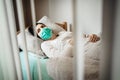 Infected woman with mask in mobile quarantine hospital units isolation.Coronavirus patient having pneumonia disease symptoms.