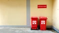 Infectious waste trashcan front of building wall in a hospital. Royalty Free Stock Photo