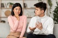 Korean Husband Catching Wife On Cheating Showing Her Phone Indoor Royalty Free Stock Photo