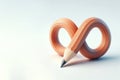 An infinite pencil curved into the shape of an infinity symbol. Space for text. Royalty Free Stock Photo