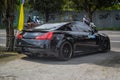 infiniti G37 or Nissan Skyline 370GT V36 coupe leaving JDM run car meet venue