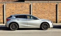 Infiniti Q60 coupe on brick wall background. It`s a crossover Suv produced by the luxury division of Nissan automaker.
