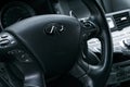 Infiniti Q70S AWD close up of steering wheel with navigation screen multimedia system. Modern luxury car interior details