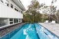 Infinity edge pool in backyard of mid century Australian home Royalty Free Stock Photo