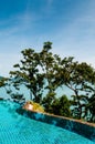Infinity edge pool with blue sea and clear sky. vertical shot Royalty Free Stock Photo