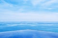 Infinity edge pool with blue sea and clear sky. Wide angle shot Royalty Free Stock Photo