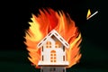 Inflamed match is falling on a house of inside a big fire, insurance concept for danger. Concept Playing With Fire