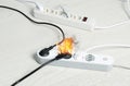 Inflamed plug in power board - electrical short circuit