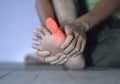 Inflammation of Asian manÃ¢â¬â¢s big toe. Concept of foot joint pain, stumble, arthritis, hyperuricema or gout Royalty Free Stock Photo