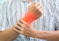 Inflammation of Asian man wrist joint. Concept of joint pain and hand problems Royalty Free Stock Photo