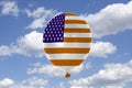 Inflatable balloon with USA flag in blue sky and clouds Royalty Free Stock Photo