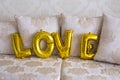 Inflatable balloons in the form of letters. Golden letters Love