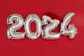 2024 inflatable balloons on red background Santa hat