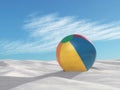 Inflatable beach ball on sand.