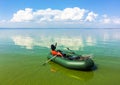 Inflatable boat in the calm river in sunny day Royalty Free Stock Photo