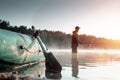 Inflatable boat on the lake at dawn, a fisherman at dawn fishing. Fishing hobby vacation concept. Copy space Royalty Free Stock Photo