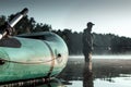 Inflatable boat on the lake at dawn, a fisherman at dawn fishing. Fishing hobby vacation concept. Copy space Royalty Free Stock Photo