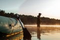 Inflatable boat on the lake at dawn, a fisherman at dawn fishing. Fishing hobby vacation concept. Copy space