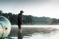 Inflatable boat on the lake at dawn, a fisherman at dawn fishing. Fishing hobby vacation concept. Copy space Royalty Free Stock Photo