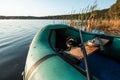 Inflatable boat on the lake at sunrise. Fishing hobby vacation concept. Copy space