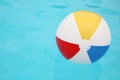 Inflatable colorful beach ball floating on water in swimming pool, space for text Royalty Free Stock Photo