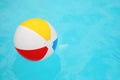 Inflatable colorful beach ball floating on water in swimming pool, space for text Royalty Free Stock Photo
