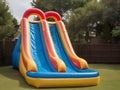 Inflatable colorful bounce house water slide in the backyard