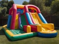 Inflatable colorful bounce house water slide in the backyard