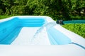 The inflatable garden pool is filled with water from a hose. Selective focus. Royalty Free Stock Photo