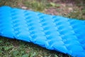 Inflatable mat for comfortable and warm sleep in a tent camping in nature. Reliable reflection of cold and protection from Royalty Free Stock Photo