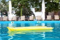 Inflatable mattress floating in swimming pool Royalty Free Stock Photo